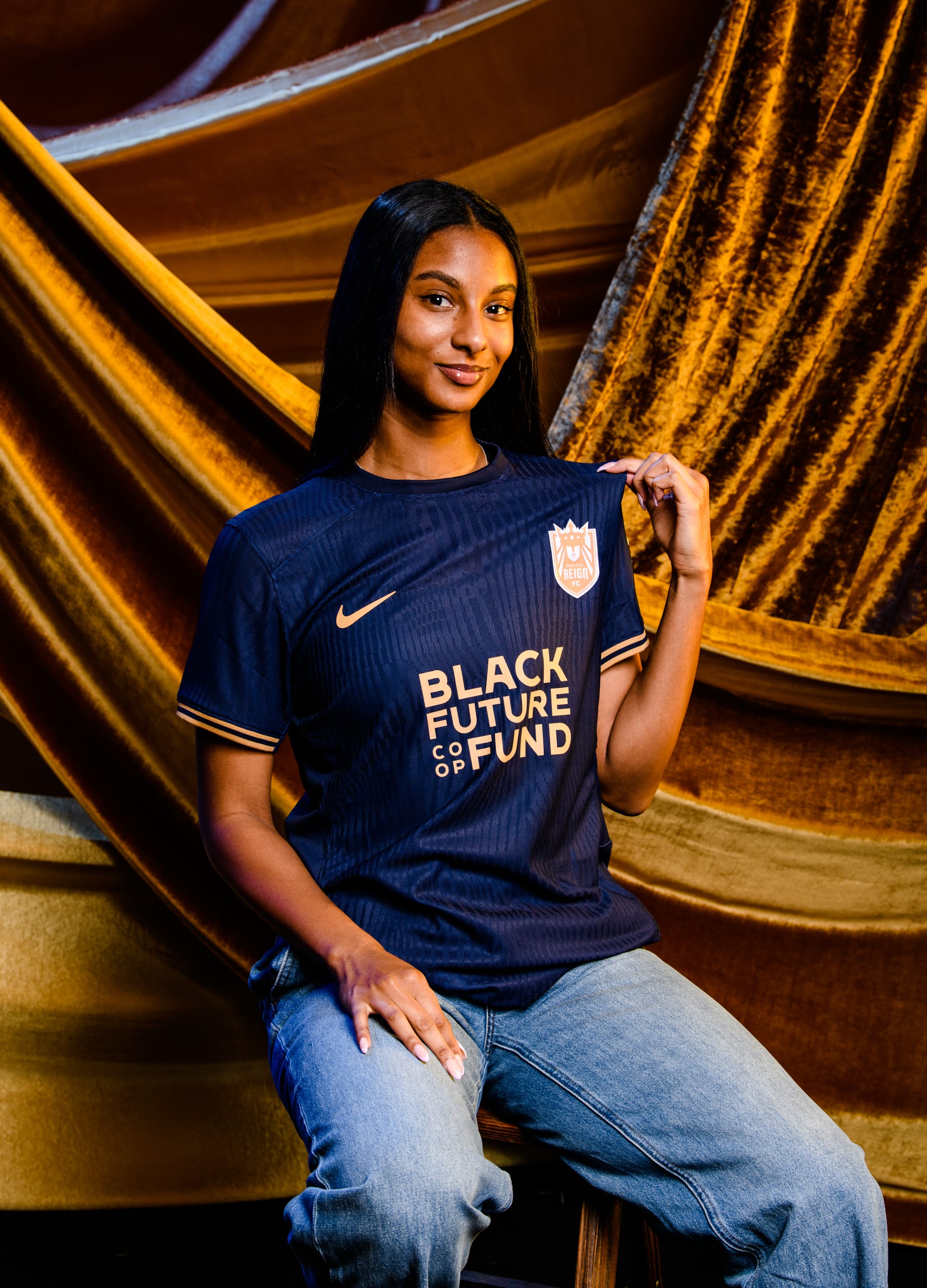 Seattle Reign FC player Ryanne Brown poses in the navy blue "Reflection" kit.