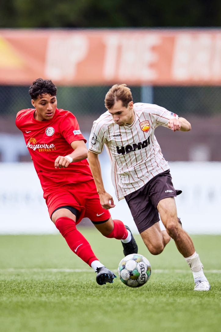 Ballard player Richie Aman dribbles past a Snohomish defender in USL2 playoff action.
