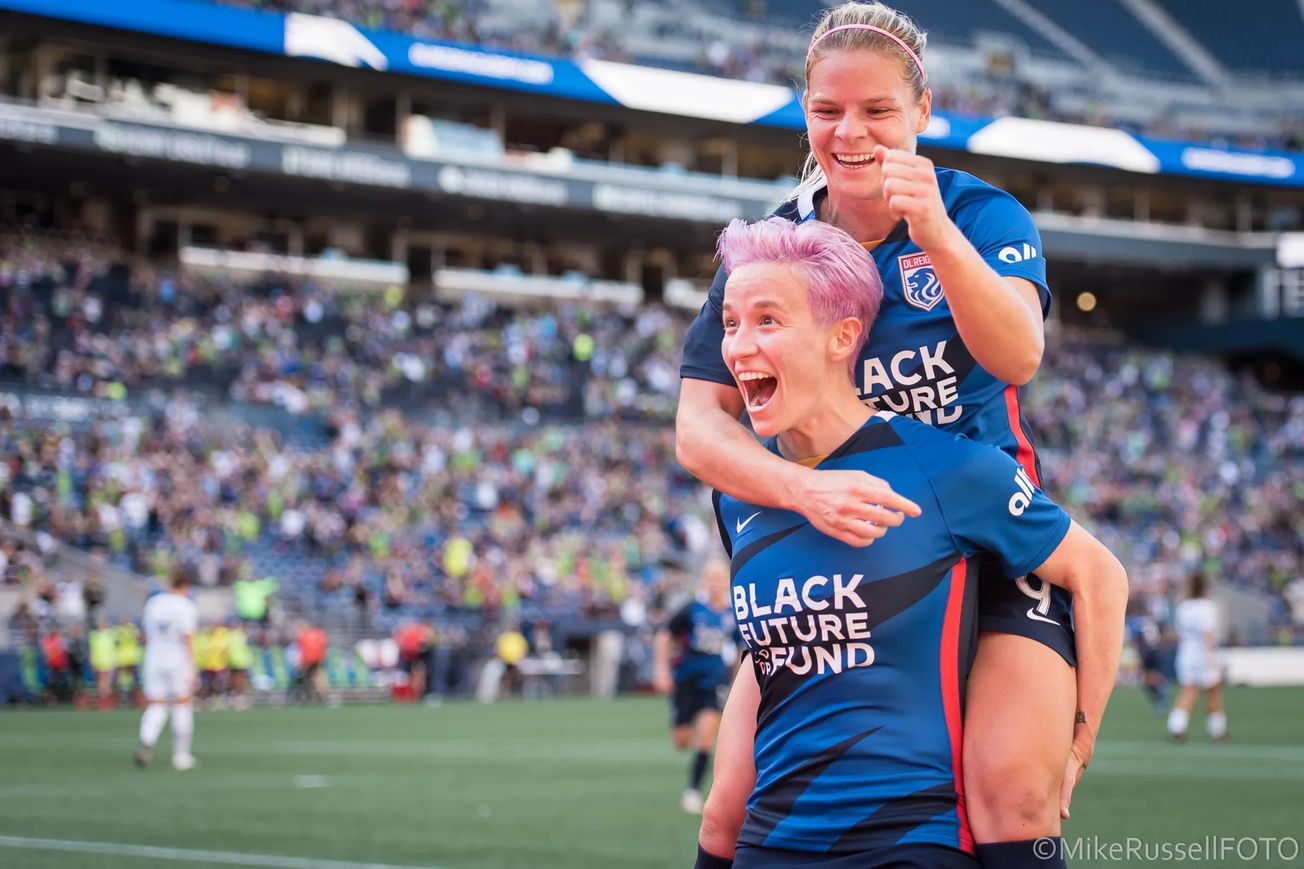 Megan Rapinoe carrying Eugene Le Sommer on her back after OL Reign defeated Portland Thorns at lumen Field in 2021.
