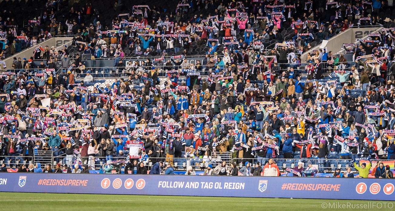 OL Reign fans hold up scarves ahead of kickoff at Lumen Field in Seattle, Washington.