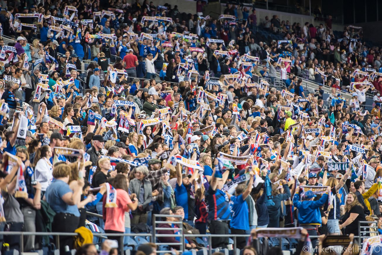 Photograph of the crowd holding scarves up at an OL Reign ga
