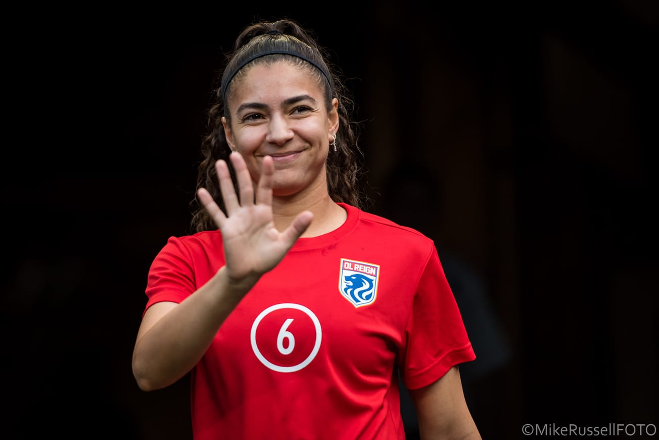 OL Reign midfielder Angelina waves ahead of a game against Racing Louisville in September 2023.