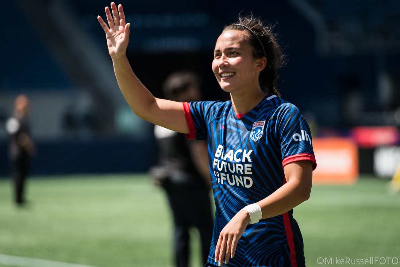 Defender Sam Hiatt waves to the crowd after an OL Reign match at Lumen Field.