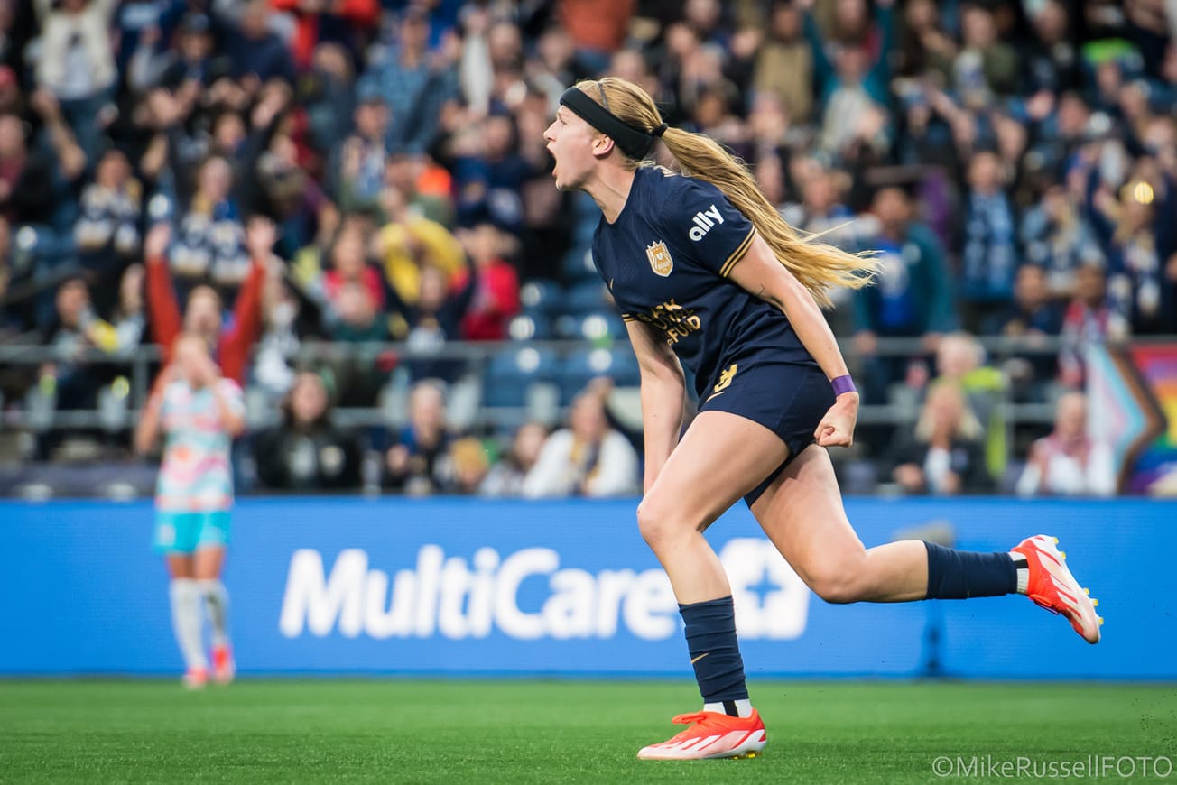 Seattle Reign forward Bethany Balcer gets hype after scoring a goal against San Diego Wave in May 2024.