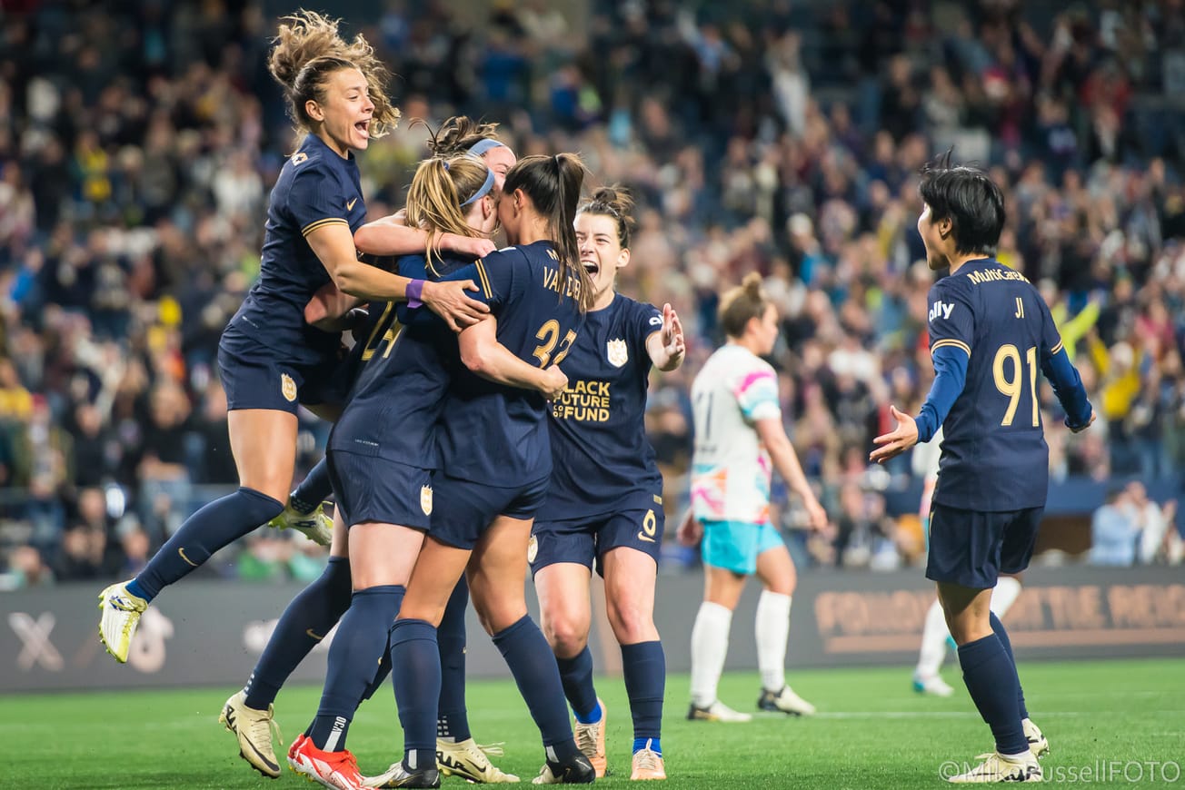 Seattle Reign players celebrate Veronica Latsko's 89th minute game winning goal over San Diego in May 2024.