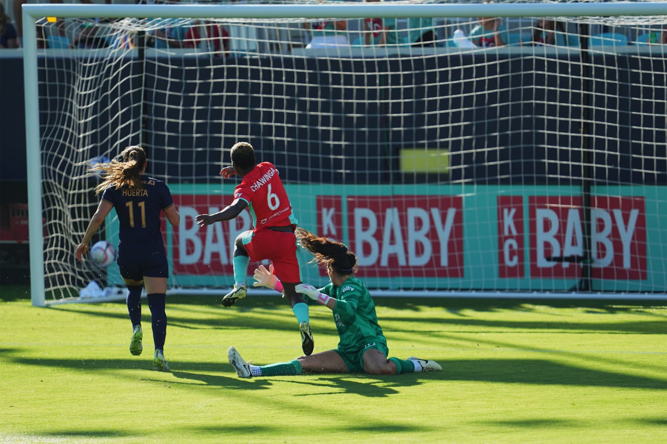 Reign goalkeeper Laurel Ivory and defender Sofia Huerta watch helplessly as KC Current forward Temwa Chawinga scores a goal.