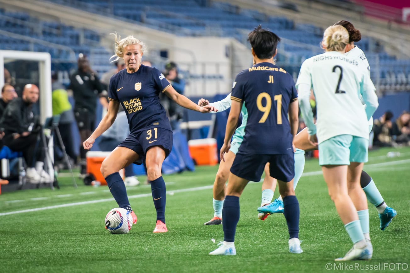 Reign fullback Hanna Glas passes a ball to teammate Ji So-Yun in a game against Gotham FC in September 2024.