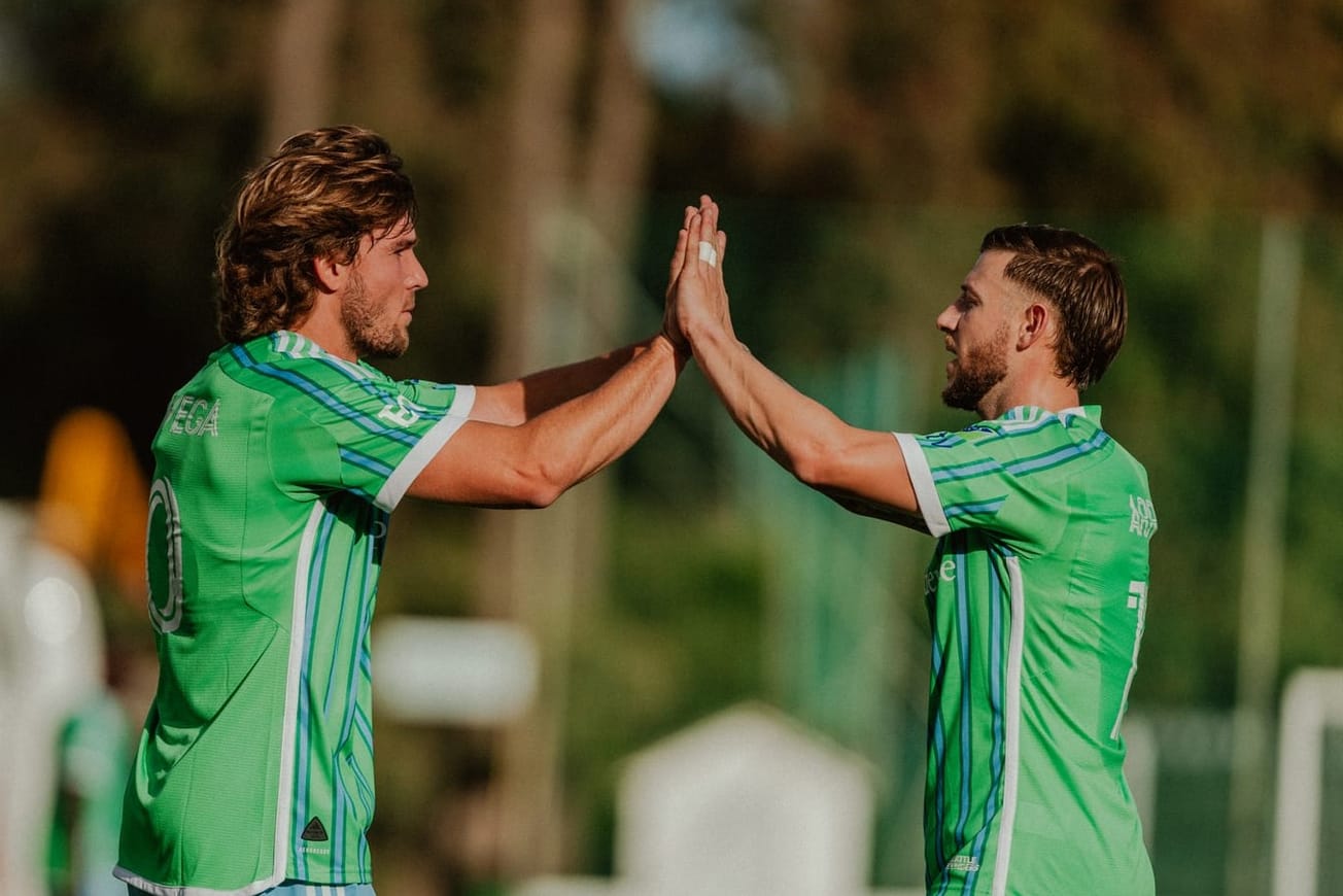 Pedro de la Vega and Paul Arriola high-five to celebrate a goal.