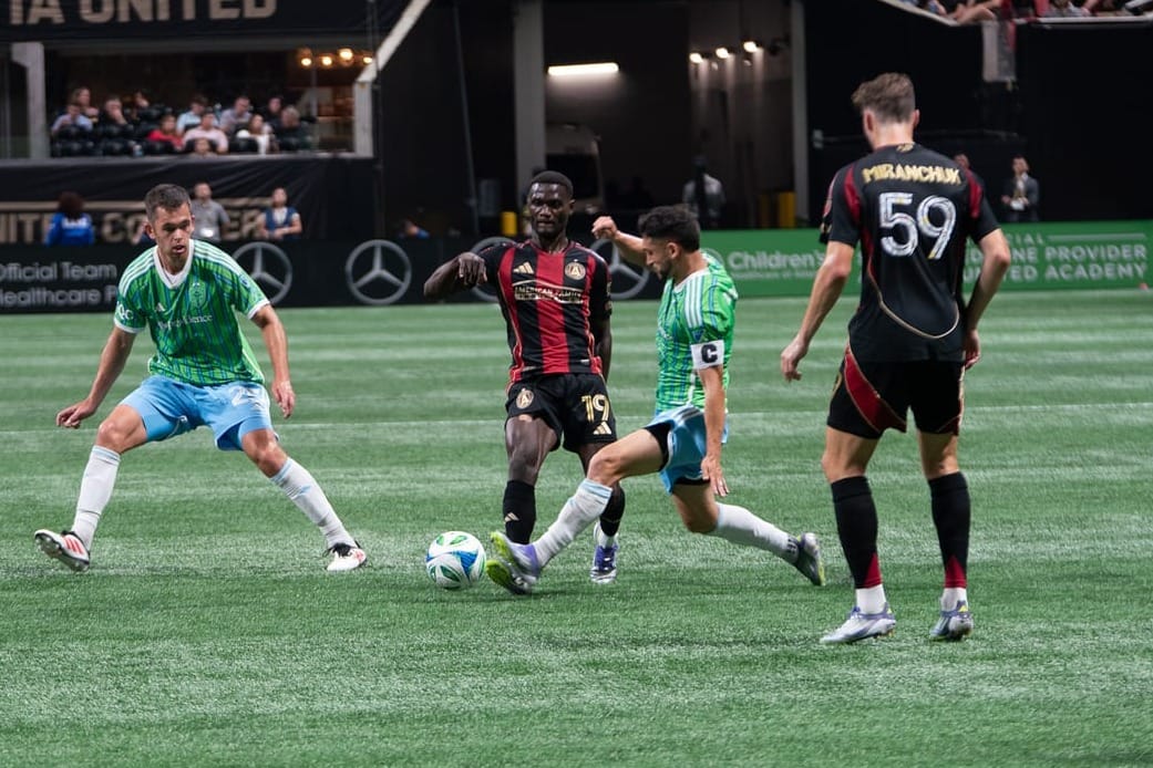 Cristian Roldan challenges for a ball against Atlanta United