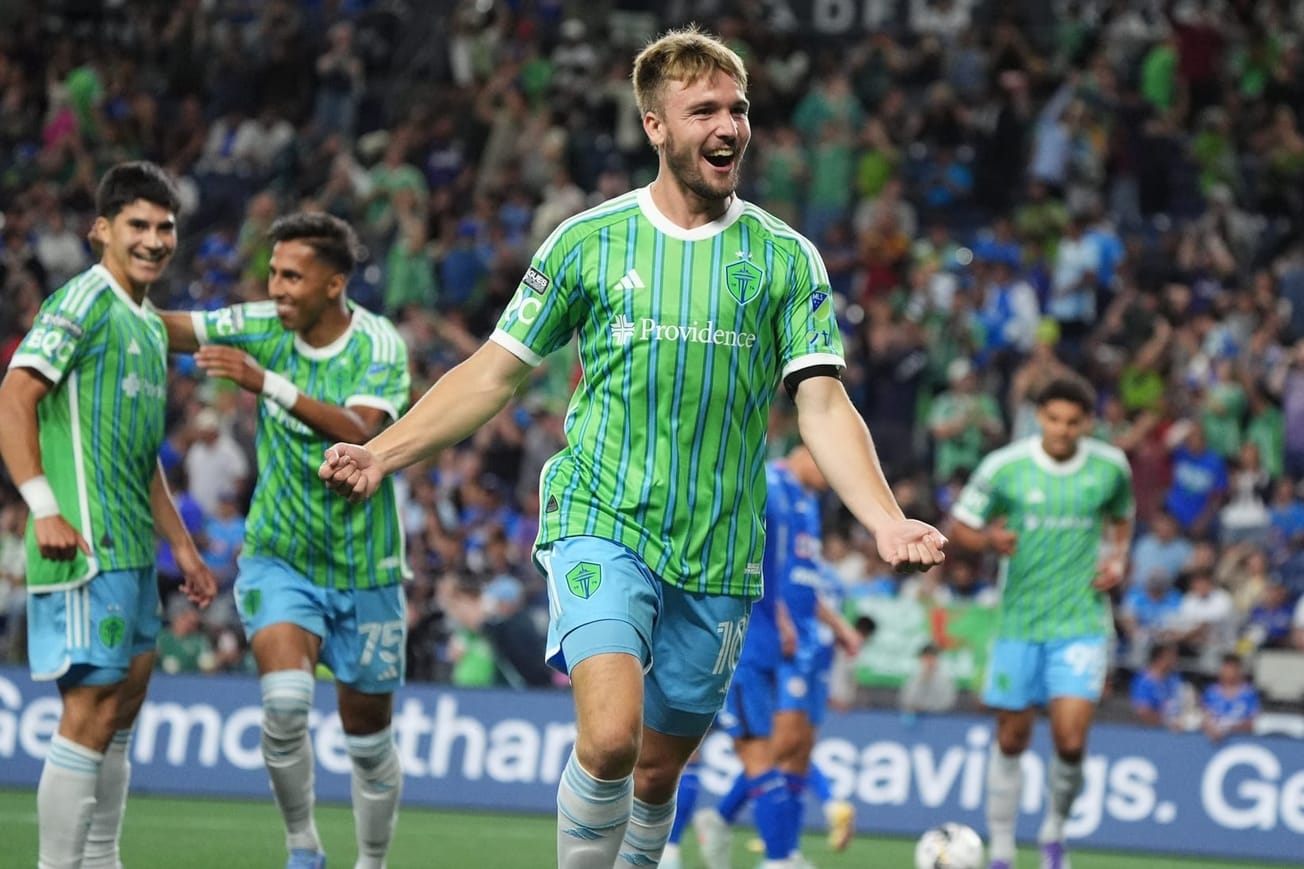 Pedro de la Vega celebrates a goal as teammates revel behind him.