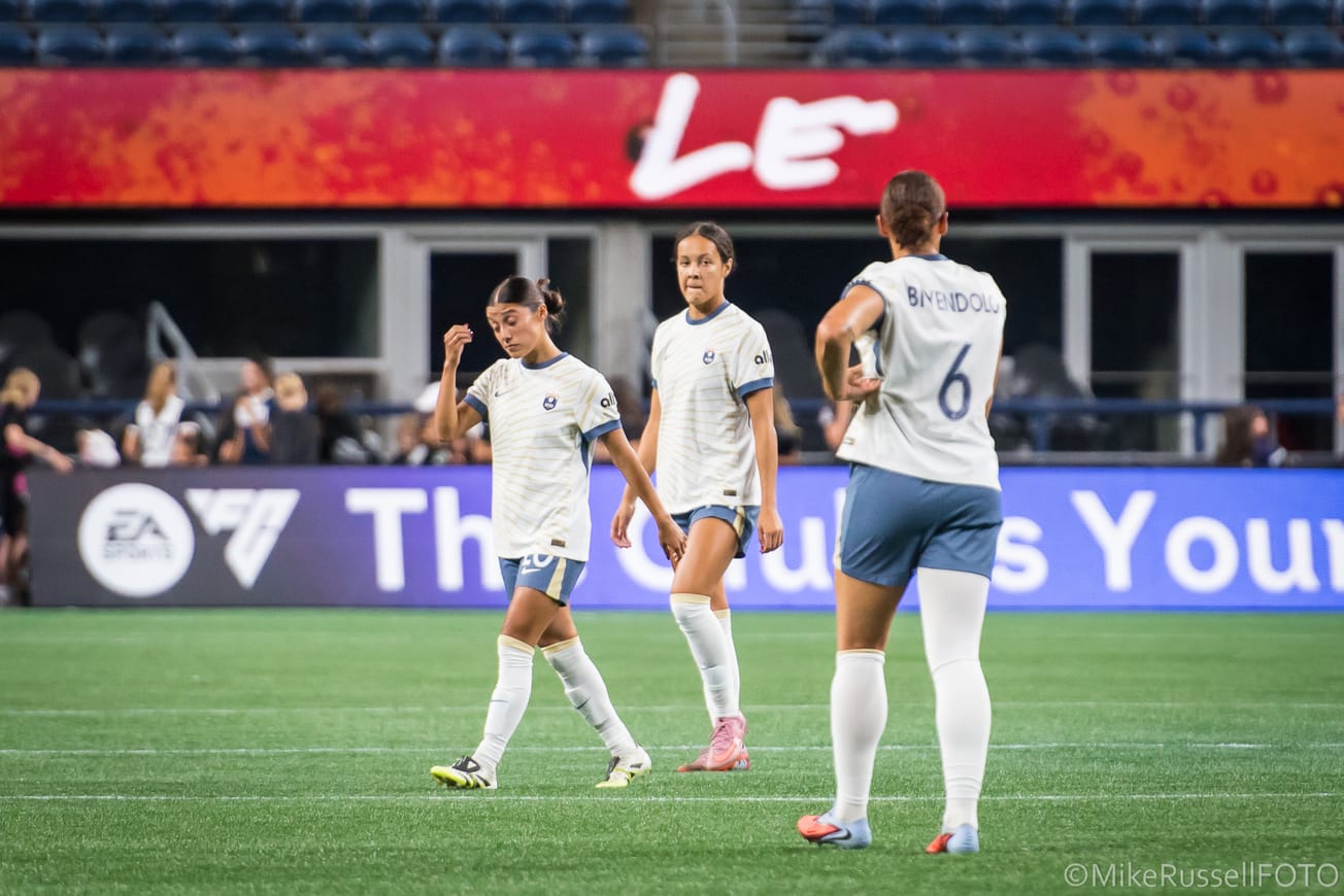 Reign players Sam Meza, Jordyn Bugg and Lynn Biyendolo react to a Chicago Stars goal late in a home game in August 2025.